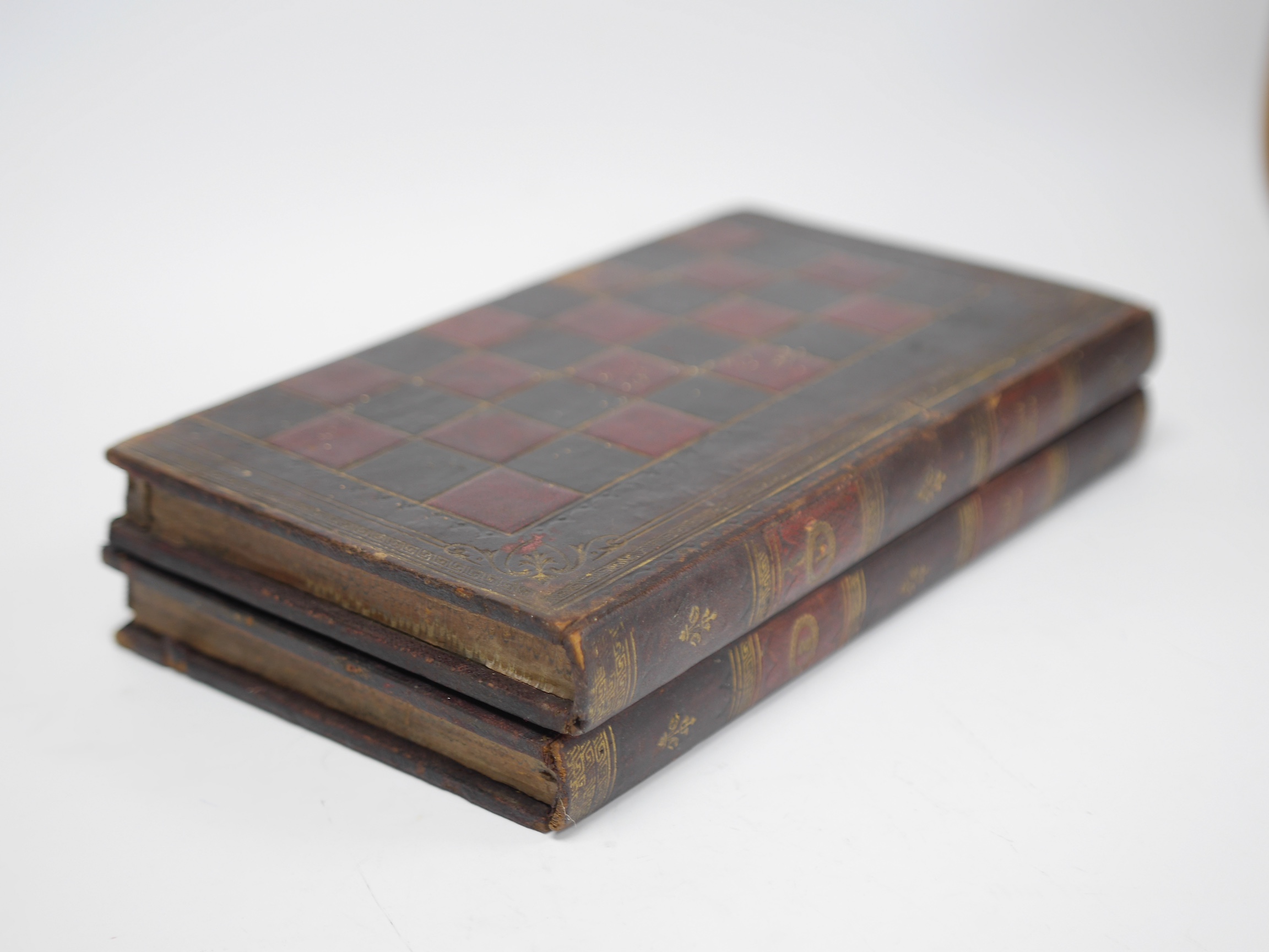 Two Victorian leather bound folding games compendium boards, both as mock bindings; English Games & History of England, with a set of bone draughtsmen. Condition - fair